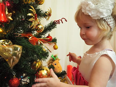 girl holding bauble of Christmas tree thumbnail