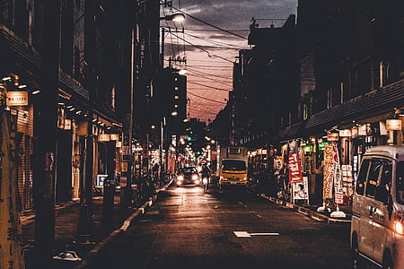 vehicles on road near buildings at nighttime thumbnail