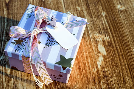 white and pink gift box on brown wooden surface thumbnail