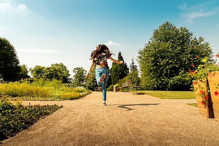 Happy young girl jump in park at summer thumbnail