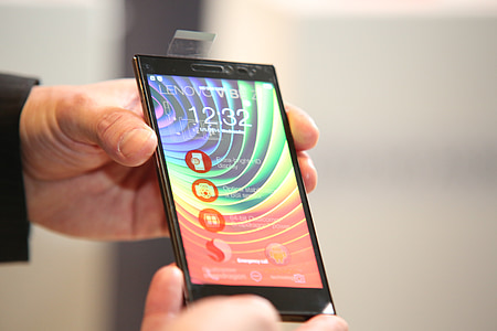 person shows black Lenovo smartphone thumbnail