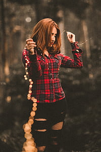 woman holding yellow string lights thumbnail