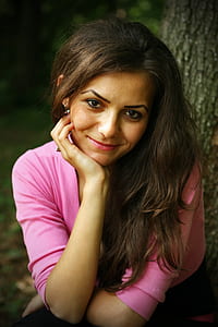 smiling woman leaning on her right hand thumbnail