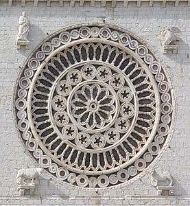 round concrete building wall decor with four white statues thumbnail