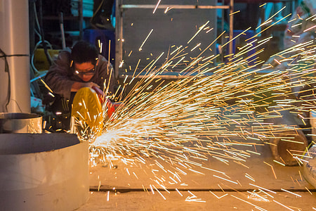 time lapse photography of man cutting metal thumbnail