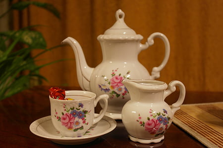 three white-and-pink floral ceramic tea set on brown wooden surface thumbnail