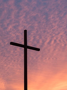 silhouette of cross under stratus clouds during golden hour thumbnail