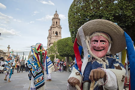 Person Wearing Blue and White Costume Taking Photo thumbnail
