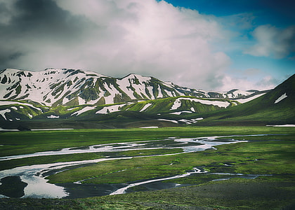 green mountains covering snow under blue sky during day time thumbnail
