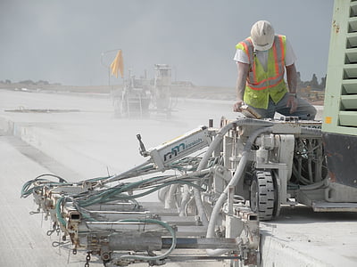 man on gray and green industrial machine during daytime thumbnail