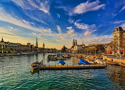body of water between concrete buildings landscape photo thumbnail