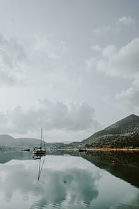 mirror photography of white sailboat thumbnail