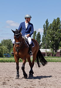 man riding a brown horse thumbnail