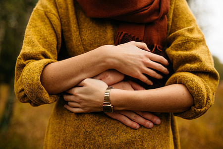 person hugging person wearing gold-colored watch thumbnail