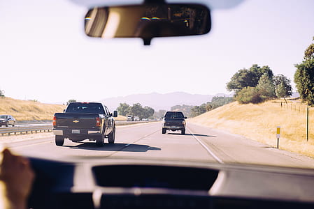 two travelling black cars on road thumbnail