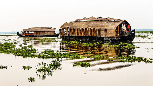 two brown wooden house boat on body of water thumbnail