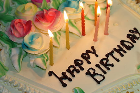 Happy Birthday cake with seven lighted candles thumbnail