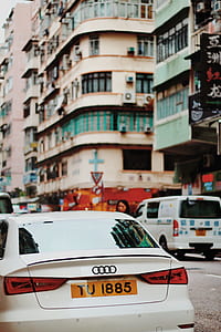 white Audi car traveling on road thumbnail