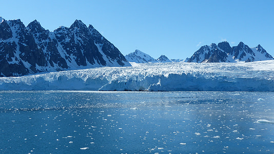 iceberg near mountains at daytime thumbnail