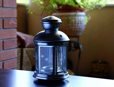 black candle rack near green plant thumbnail