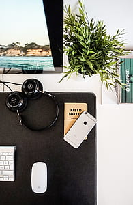 space gray iPhone 6 beside black full-size headphones thumbnail