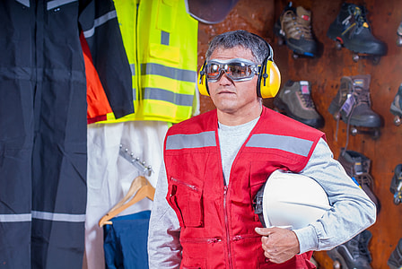 man wearing red zip up vest carrying white hardhat thumbnail