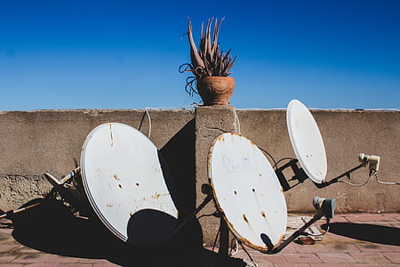 three gray parabolic dish near wall thumbnail
