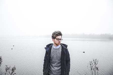 man standing near body of water thumbnail