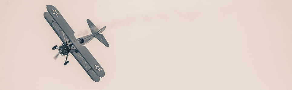 black propeller plane flying on sky thumbnail