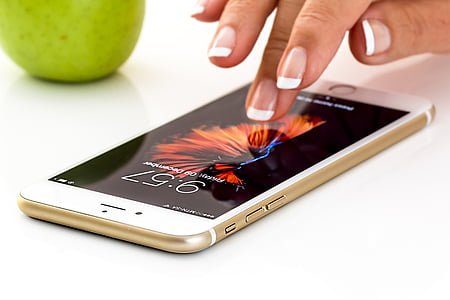 person touching gold iPhone 6 thumbnail