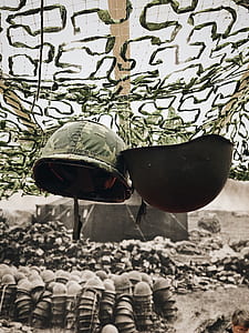 two green combat helmets thumbnail