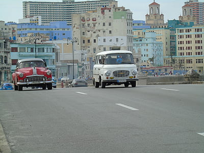 white and red cars passing through gray asphalt thumbnail