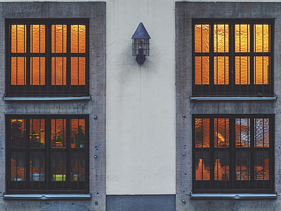 black wall sconce between two window panes thumbnail