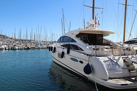 white yacht docked near boat thumbnail