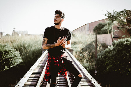 man in railroad during daytime thumbnail