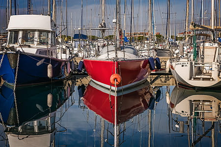 boats on body of water beside boat docks thumbnail