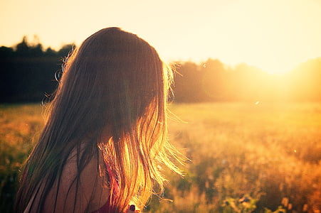 shallow focus photography of blonde hair woman surrounded by plants thumbnail