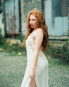 selective focus photo of woman wearing white sleeveless side-slit dress thumbnail
