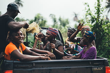 group people people sitting on Toyota Hilux pickup truck thumbnail