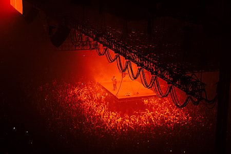 man standing on stage surrounded by people thumbnail