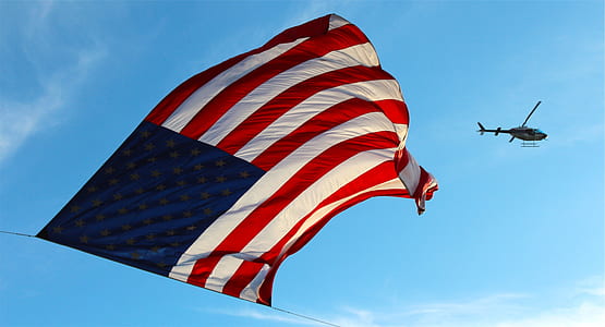 waving flag of United States of America under helicopter thumbnail