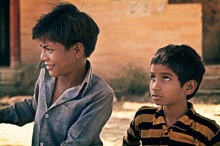 two boys standing near wall thumbnail