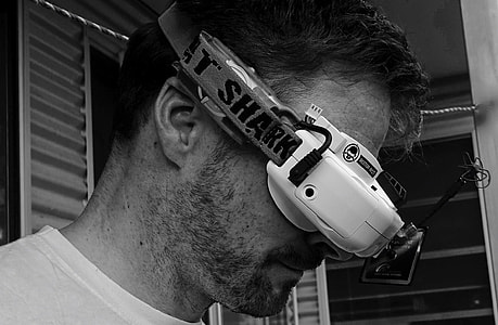 grayscale photo of man wearing FPV drone goggles thumbnail