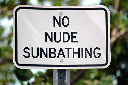No Nude Sunbathing sign at daytime thumbnail
