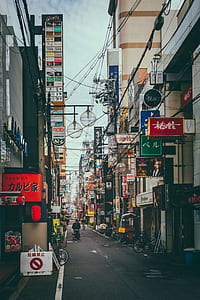 man pushing cart on street at daytime thumbnail