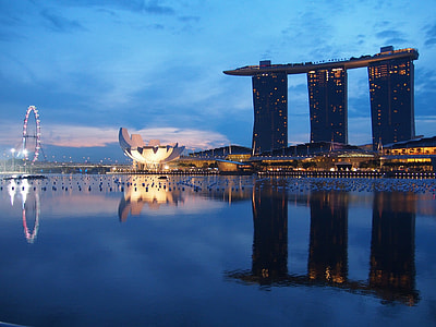 landscape photo of three buildings near on body of water thumbnail