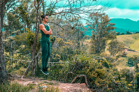 man jumping near tree thumbnail