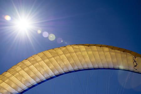 brown parachute flying under sun thumbnail