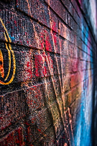 brown brick wall with graffitis thumbnail