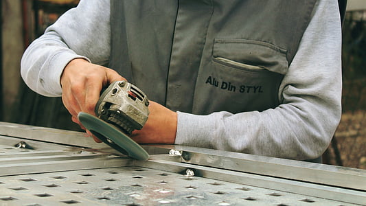 man holding gray cordless angle grinder thumbnail